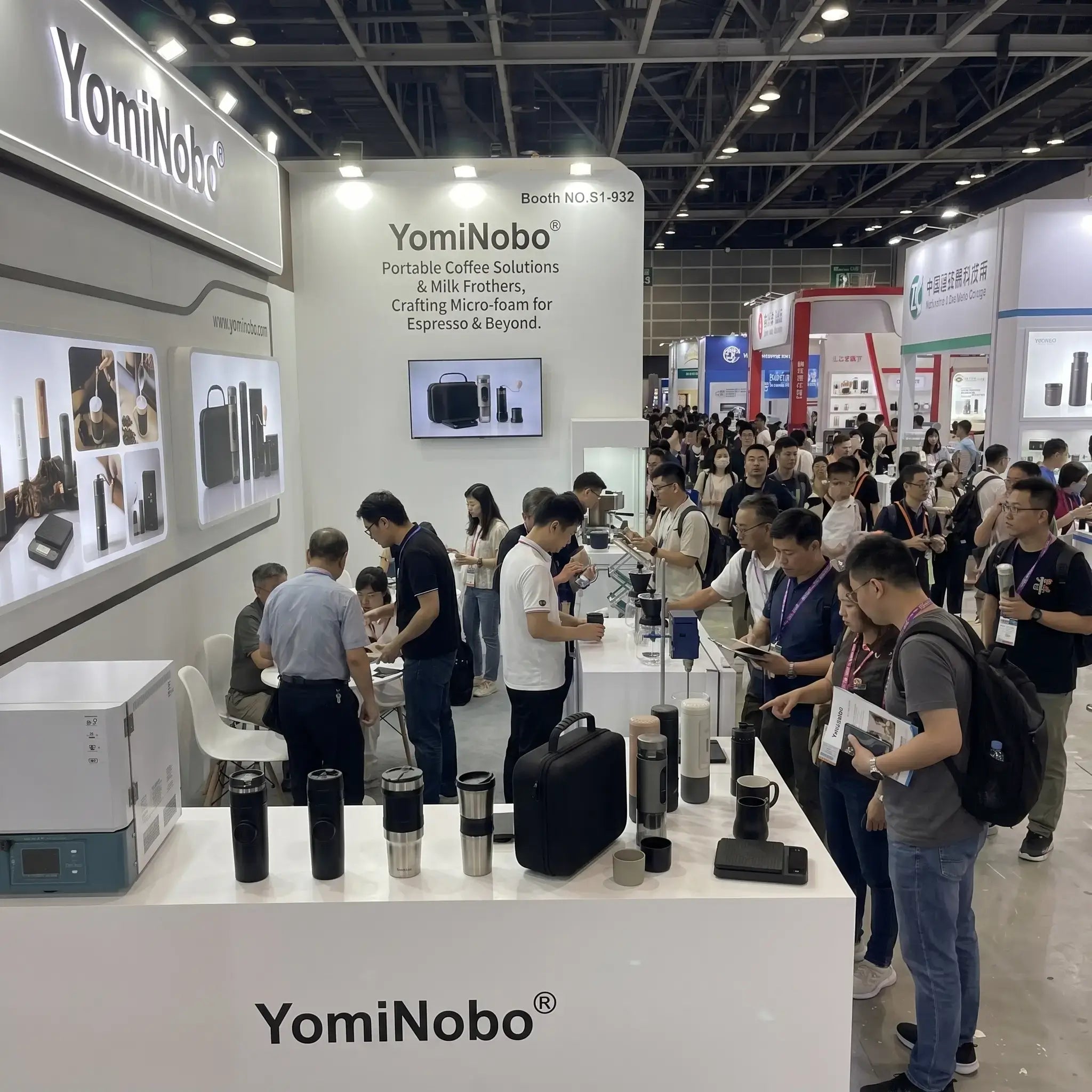 YomiNobo exhibition booth with visitors exploring portable espresso machines at a coffee trade show