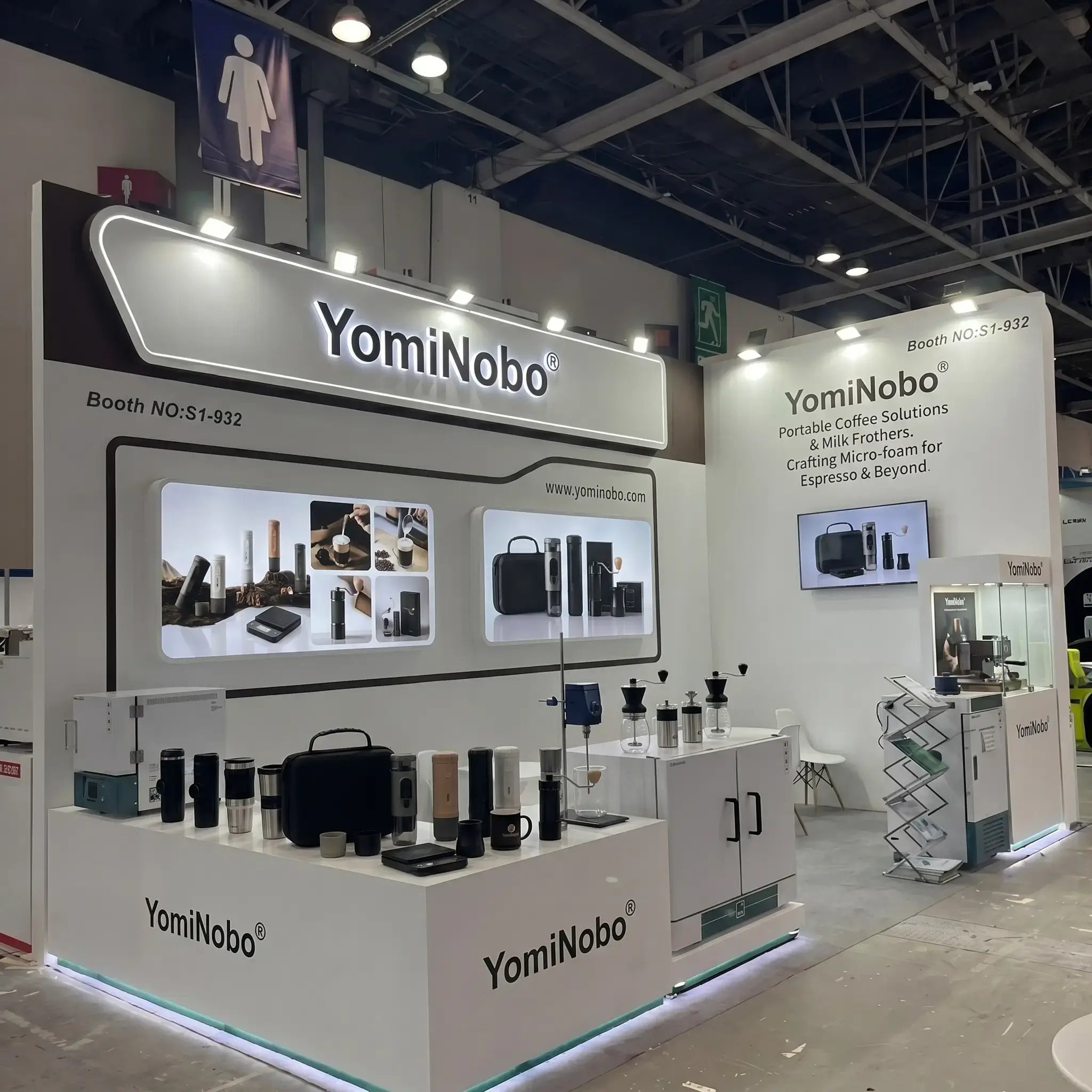 YomiNobo staff presenting portable espresso machine to trade show visitor