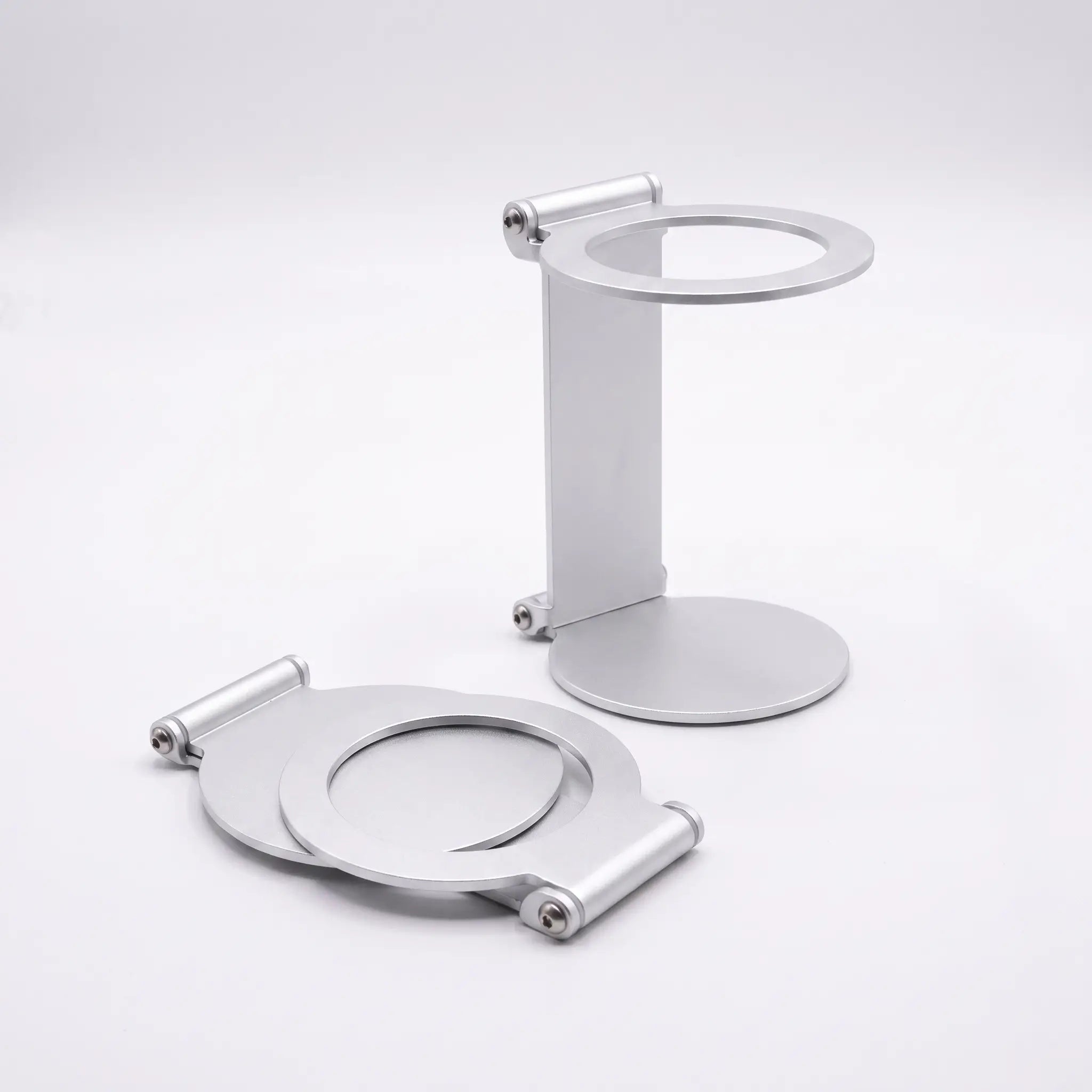 Silver foldable metal espresso machine stand shown in upright and flat positions