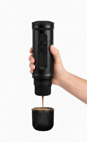 Using the YomiNobo Portable Espresso Machine outdoors at a campsite, demonstrating rich crema extraction with 20-bar pressure