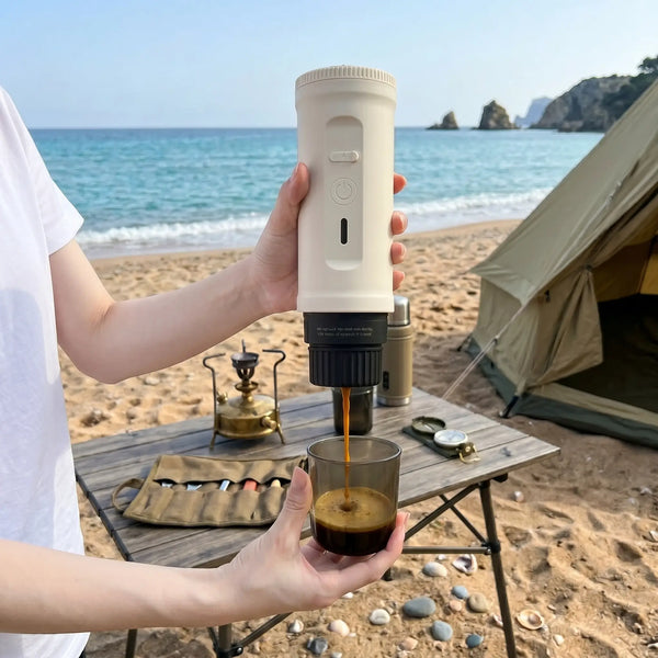 YomiNobo portable espresso machine on a camping table by the beach